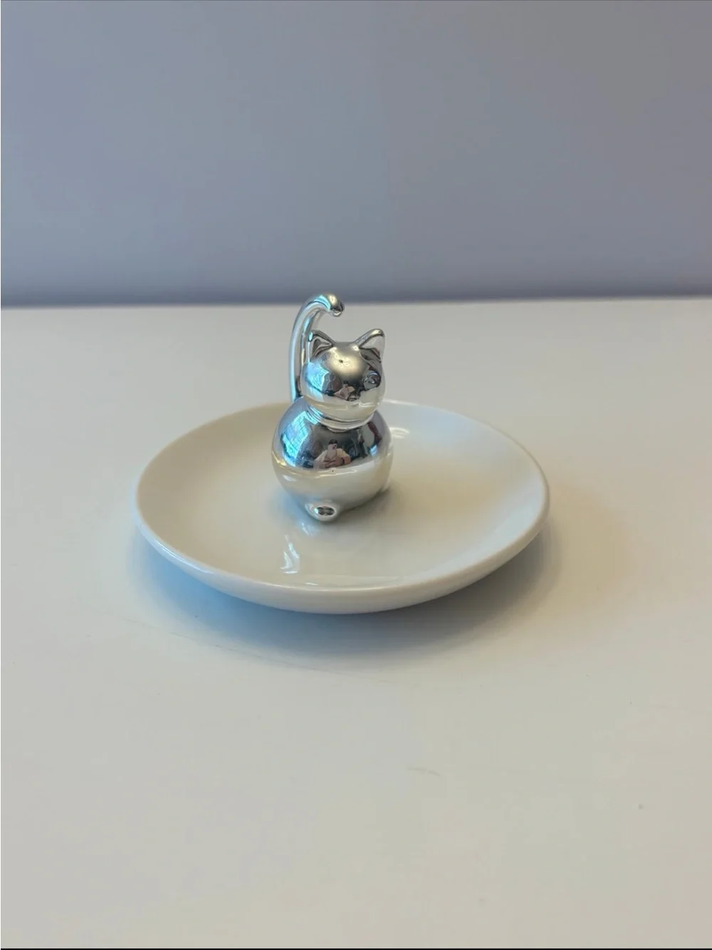 Silver Cat Ring Holder on White Ceramic Dish
